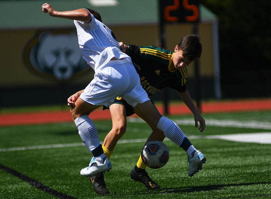 Rock Bridge defender Tristan Greenplate makes a block against Jonathan Marshall